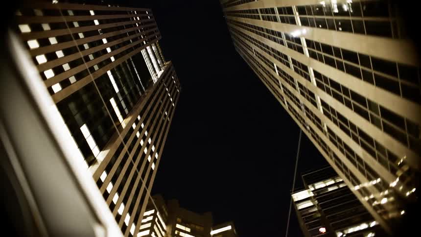 Upward view of modern buildings at night
