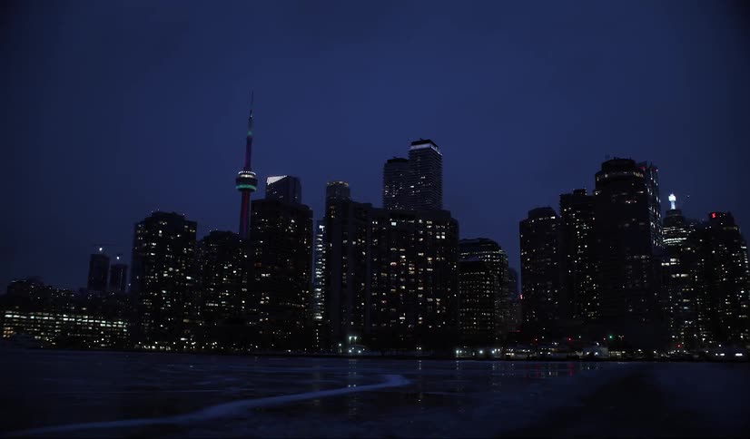 Modern skyscraper metropolises seen at night by the sea