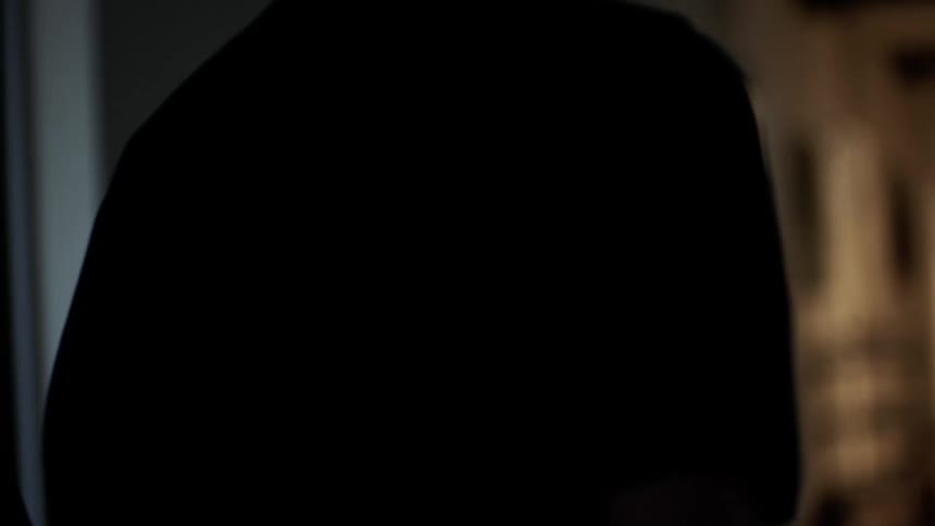 Silhouette of two people back to back running down a hallway