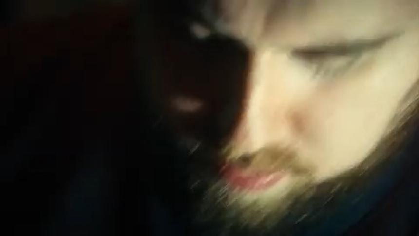 Portrait of a bearded man singing and flashing lights on his face