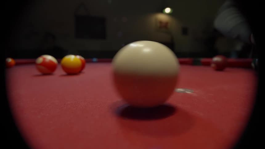 Close up of a pool table with balls moving