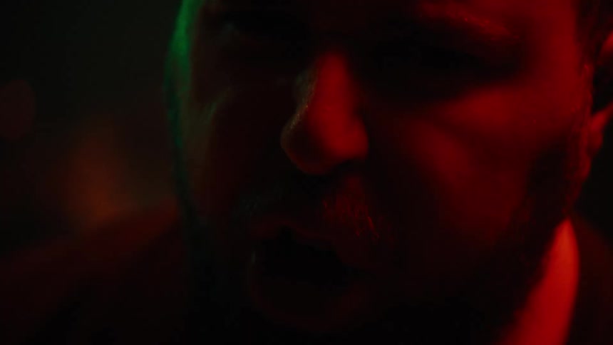 Portrait of a bearded man singing vibrantly