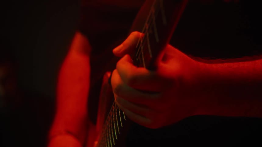Pair of hands playing guitar