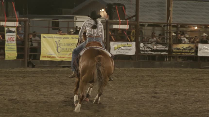 Cowgirl riding a horse at a rodeo