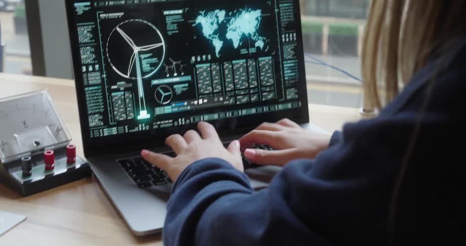 Pair of hands typing on an open laptop on the table