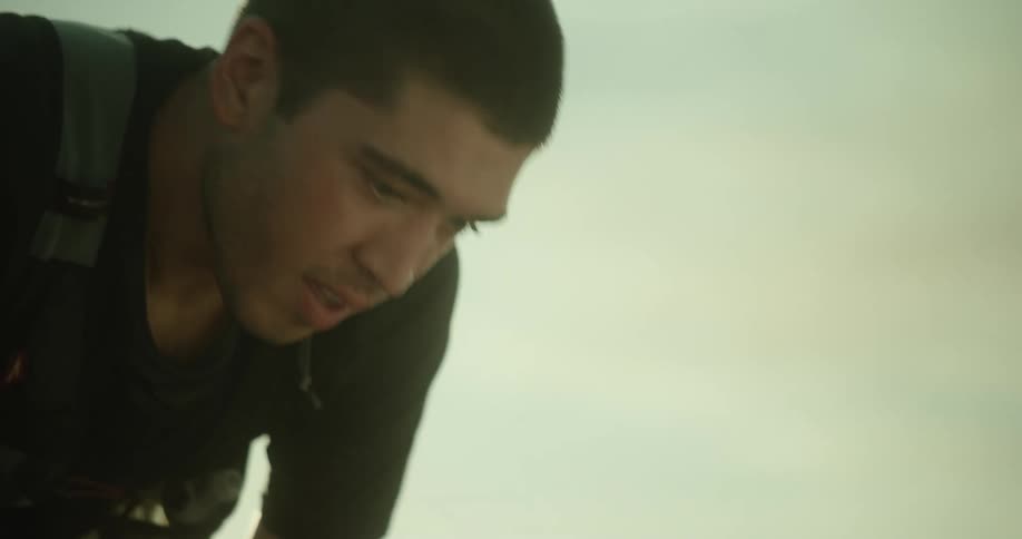 Panting and sweaty man takes off his cap and takes a deep breath