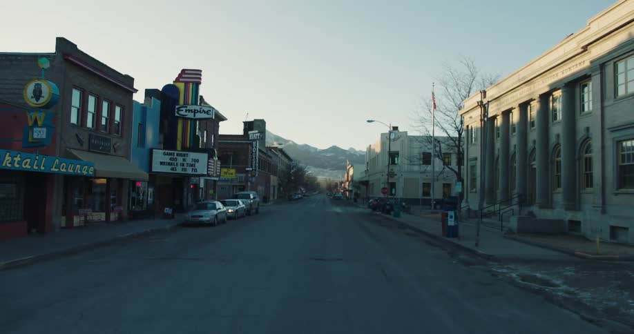 Street in a quiet city with mountains on the horizon
