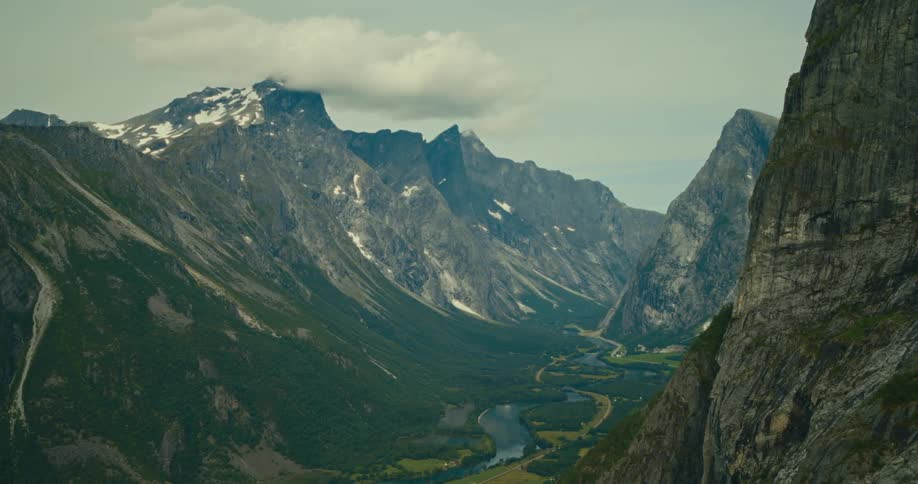 Aerial view of a snowy mountain valley with a river