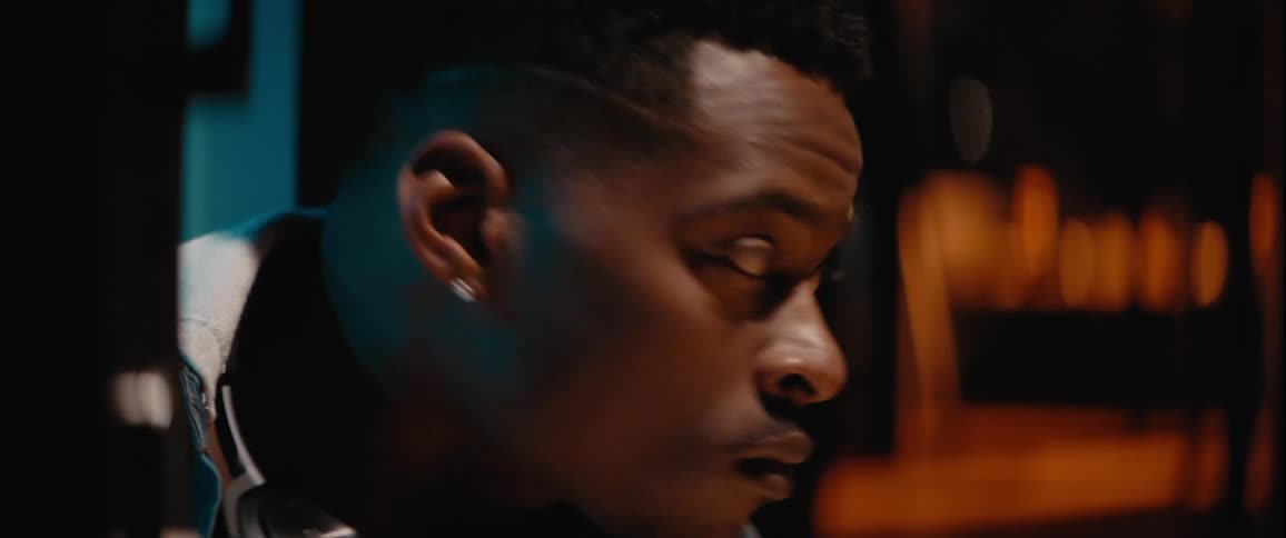 Man with intense expression looks to the sides