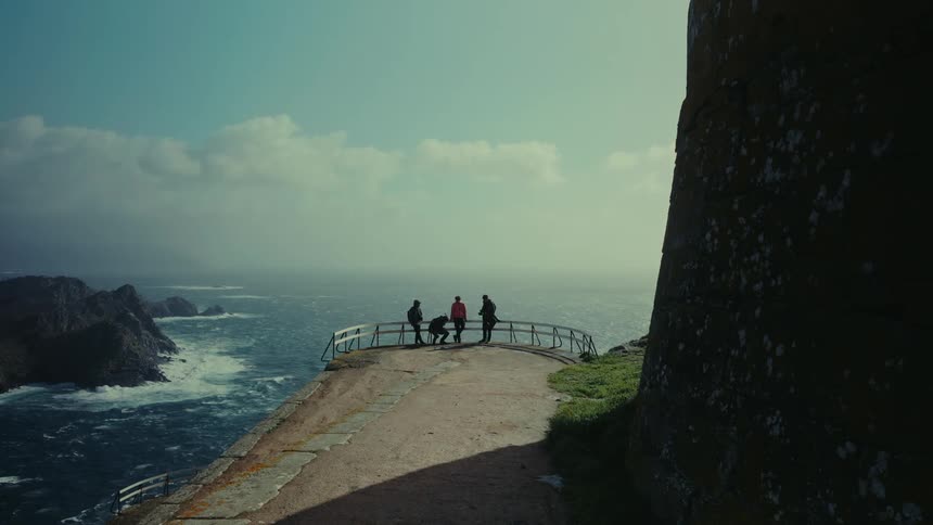 Travelers on a cliff with a seaside enclosure