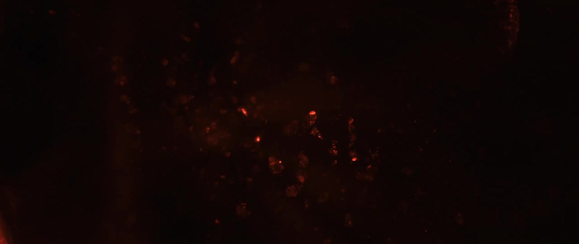 Low fire burning abstractly against a dark background