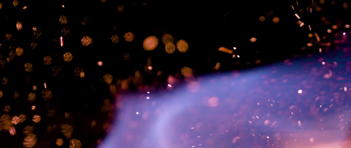 Close up of a fire flame with an abstract splash against a black background
