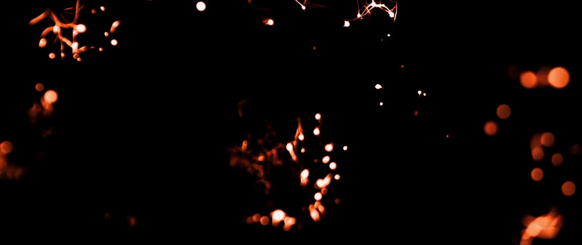 Flames burn along tendrils in the dark
