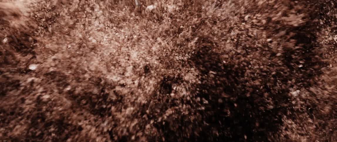 Close up of a brown powder in abstract motion