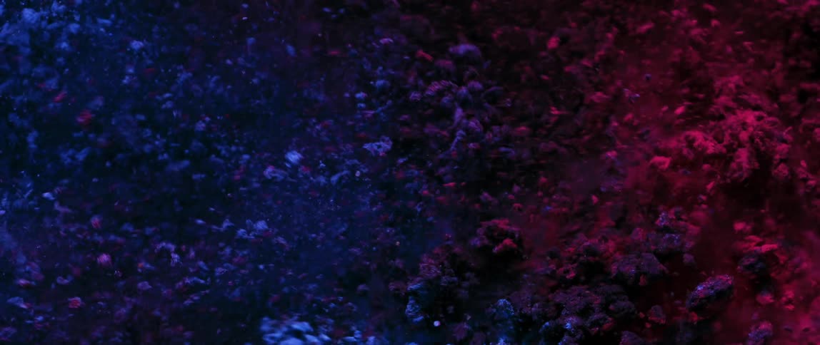 Blue and red dust particles in abstract flickering motion
