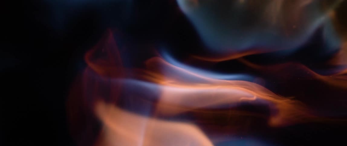 Blue and red fire flames against a black background