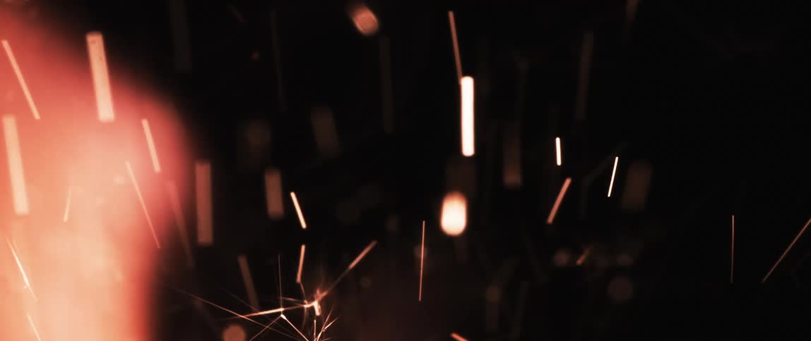 Embers from a a fire rising against black background