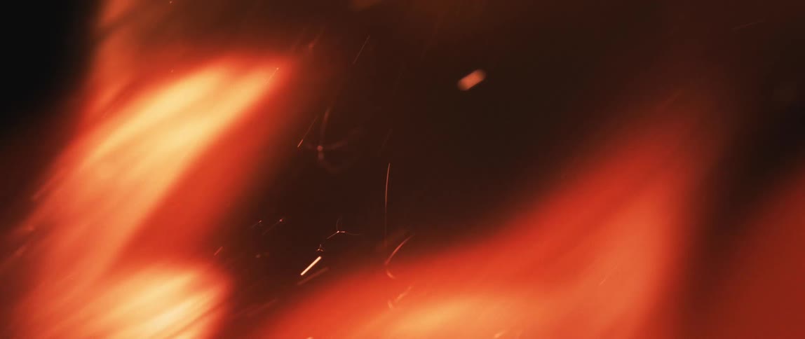 A closeup of sparks and flames against a dark background