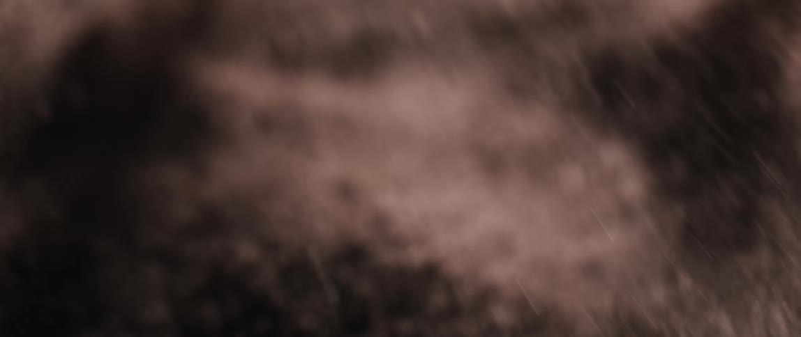 Tiny particles of dirt and dust explode into the air illuminated by the light as they scatter in all directions