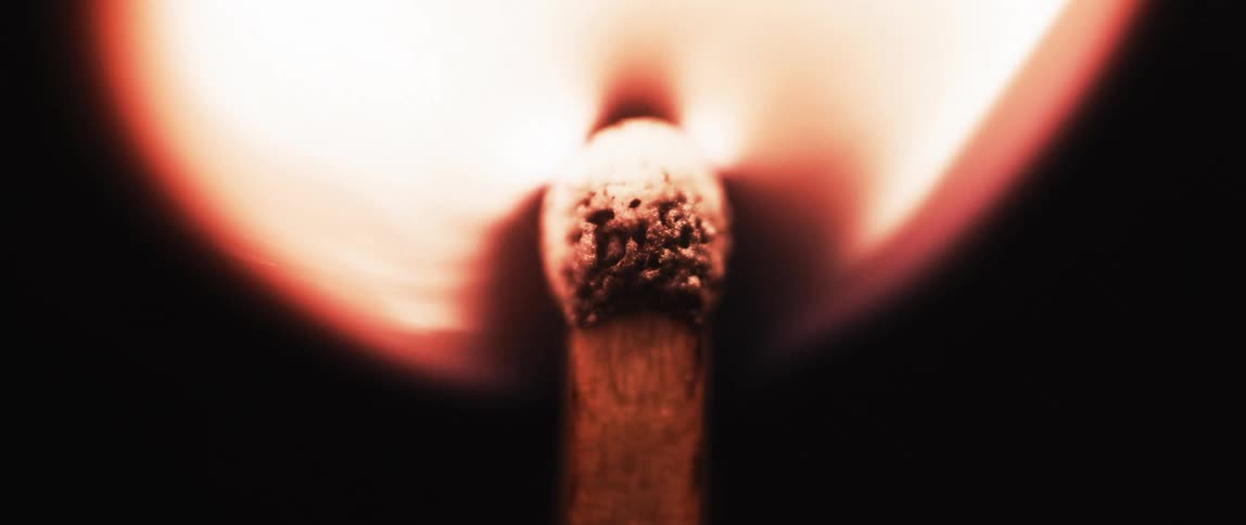 A match is lit and slowly goes out