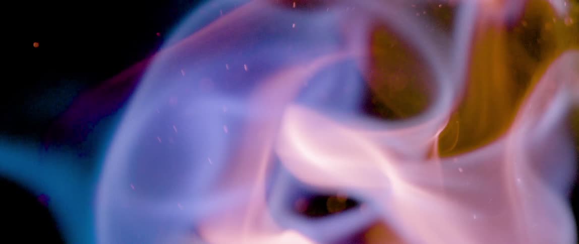 Extreme close up of fire flames against a dark background
