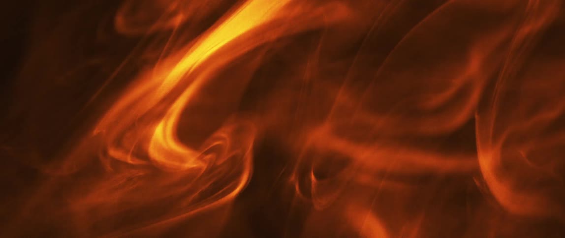 Orange and yellow smoke rising against black background