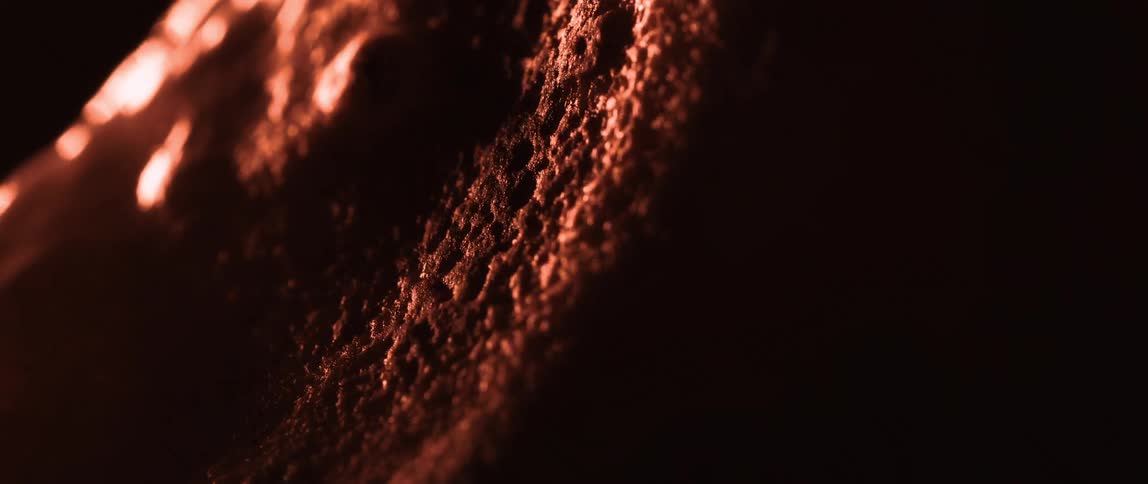 A close up of a surface bubbling and charring under intense heat