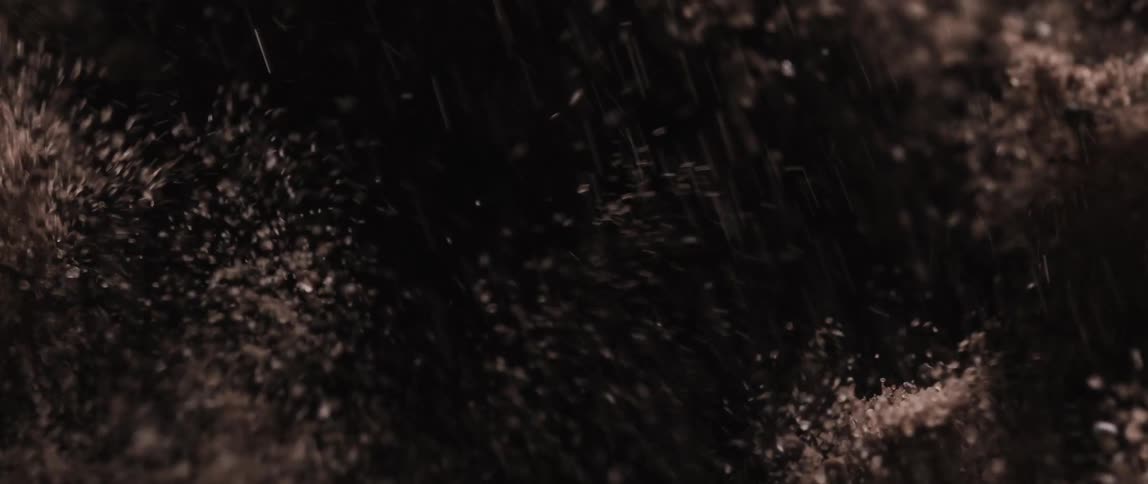 Extreme close up on an abstract brown powder in motion