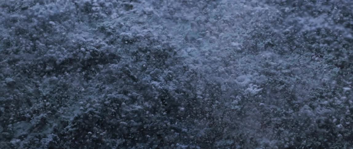 Stray particles spray into the air while the mass is shaken rapidly