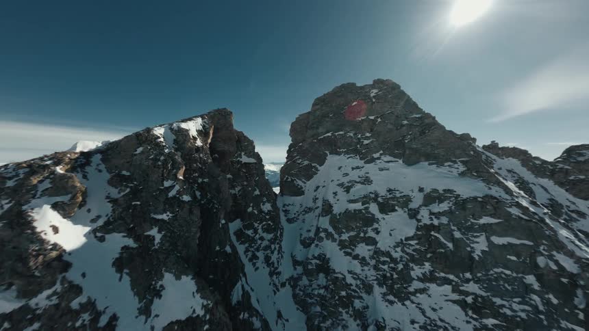 Aerial view of a rocky mountain valley covered in snow