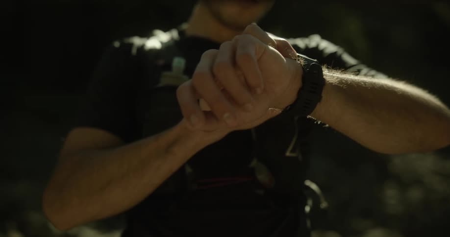 A man checks his watch and runs off
