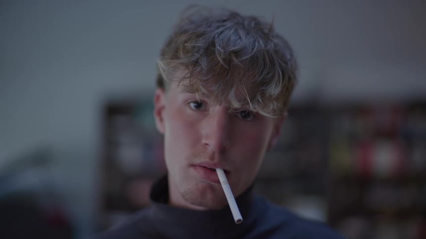 A man has a cigarette in his mouth
