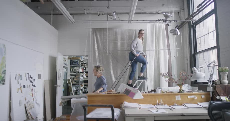 Two employees are working in the office