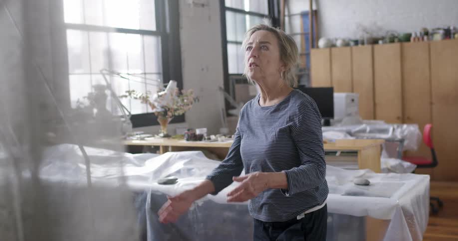 A tailor is examining a sheet of fabric