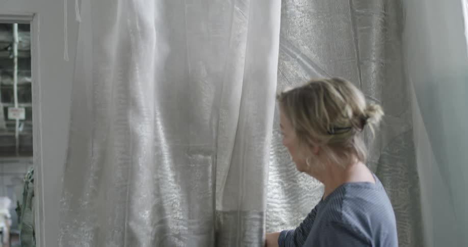 Woman working on a gray fabric