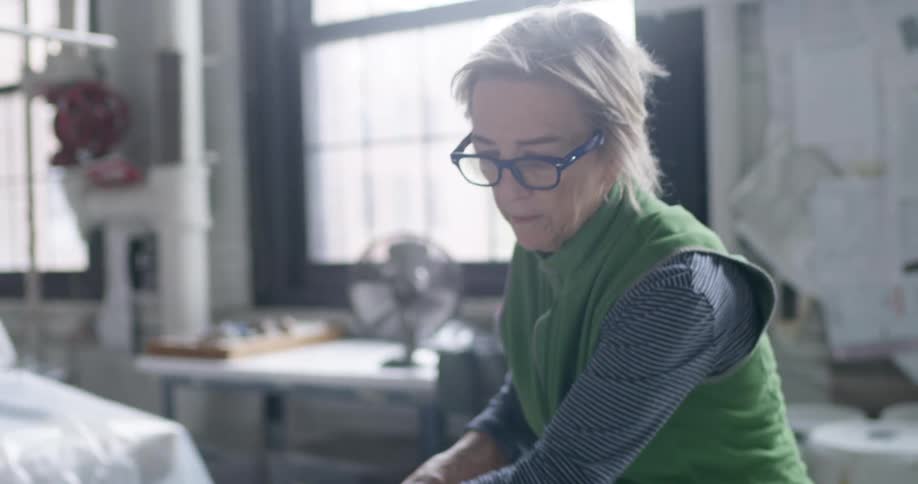 A woman in a factory looks through swatches