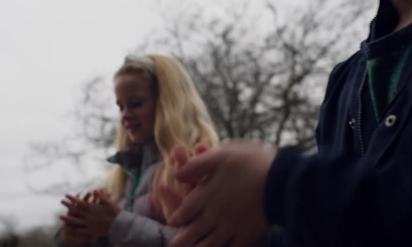 Pair of hands of two children playing outdoors