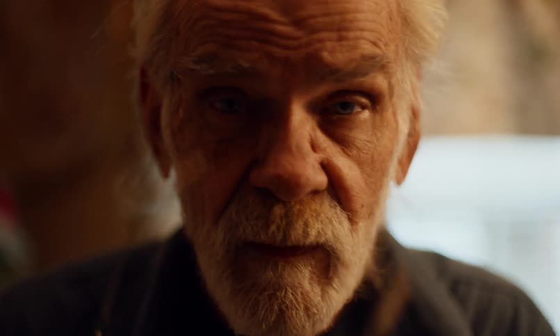 Portrait of an elderly man with glasses talking