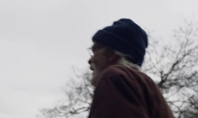 A clip of an elderly man walking towards a boy and girl