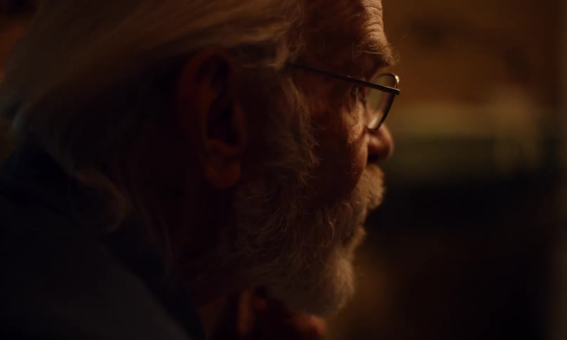 Elderly man cutting his beard