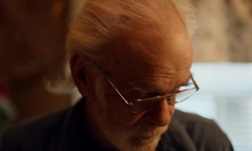 A clip of an elderly man combing