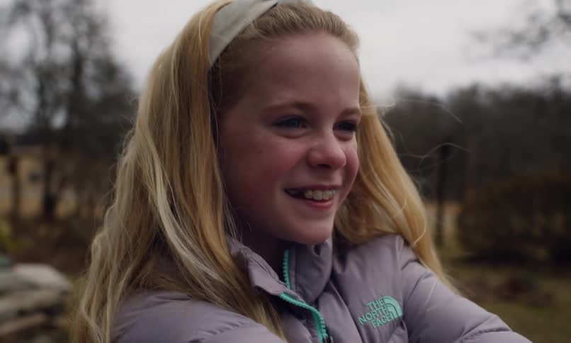 Portrait of a blonde girl playing outdoors