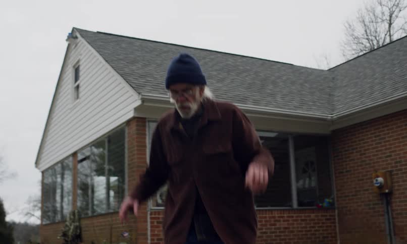 Elderly man in a backyard playing hopscotch