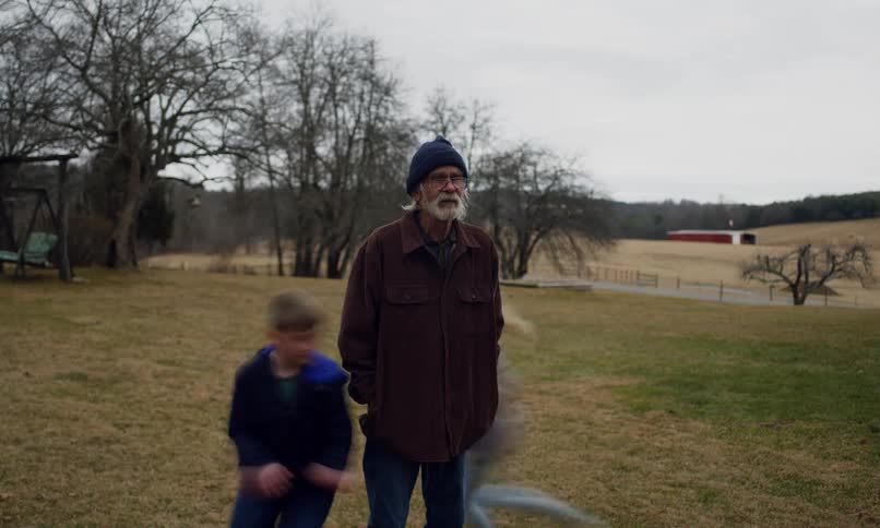 A clip of kids running round an elderly man