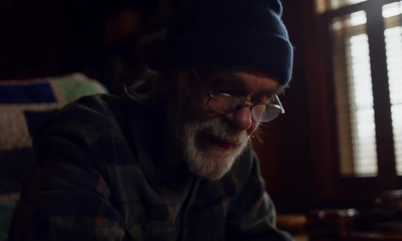 Grandfather sitting in the living room with his granddaughter