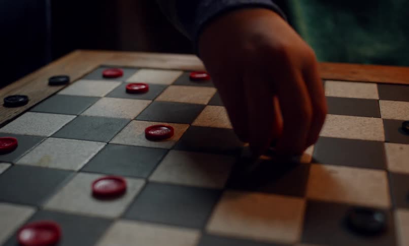 Hands of three different people playing board game