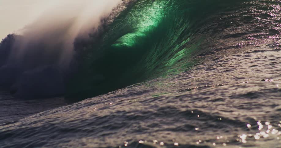 A wave curls as it approaches and crashes violently