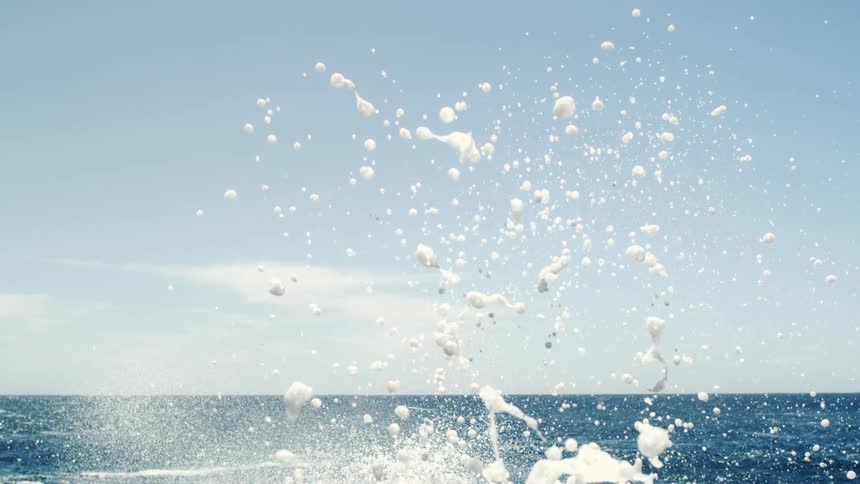Foamy water splash in a vast blue ocean