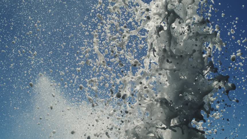 Foamy splash of water against a blue ocean