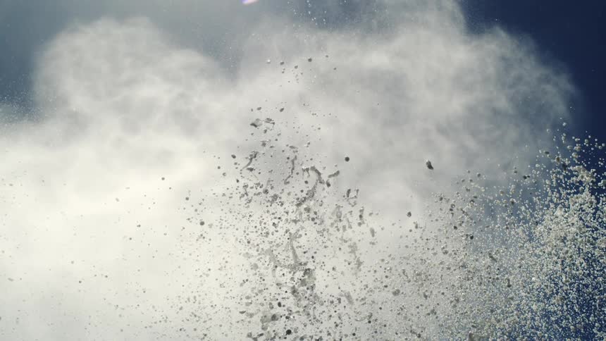 A mist falls toward water droplets splashing up